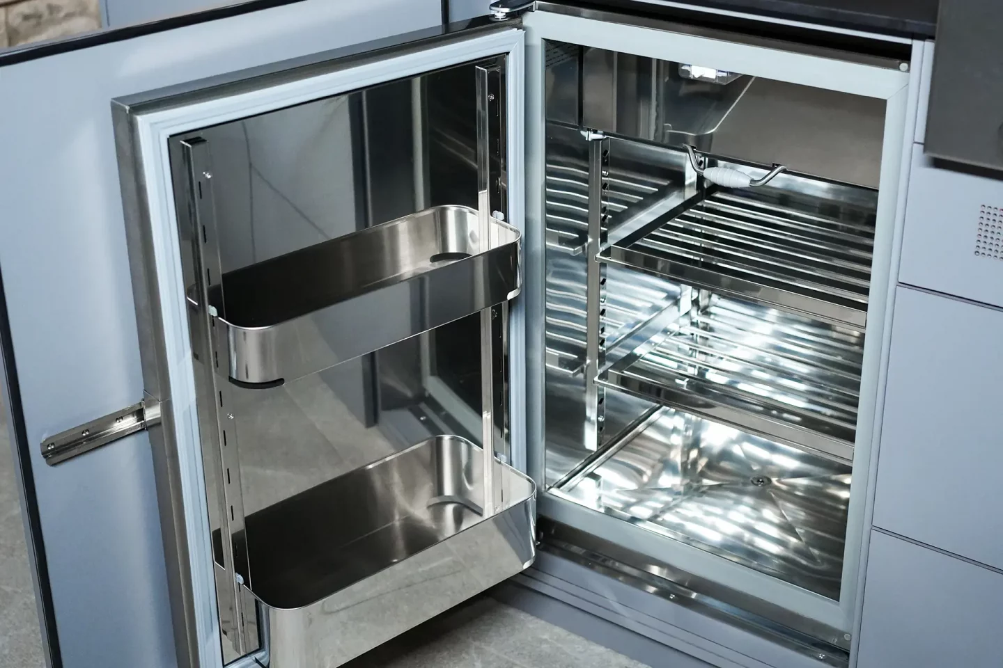 Open fridge door of outdoor kitchen